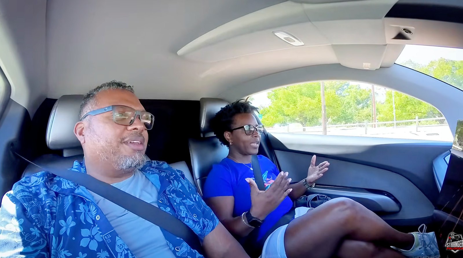 Hank and Lola Strange seated together inside Tesla's Cybercab in Austin