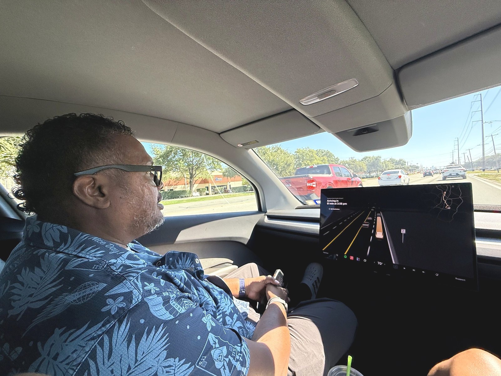Hank Strange seated inside Tesla's Cybercab during his passenger ride