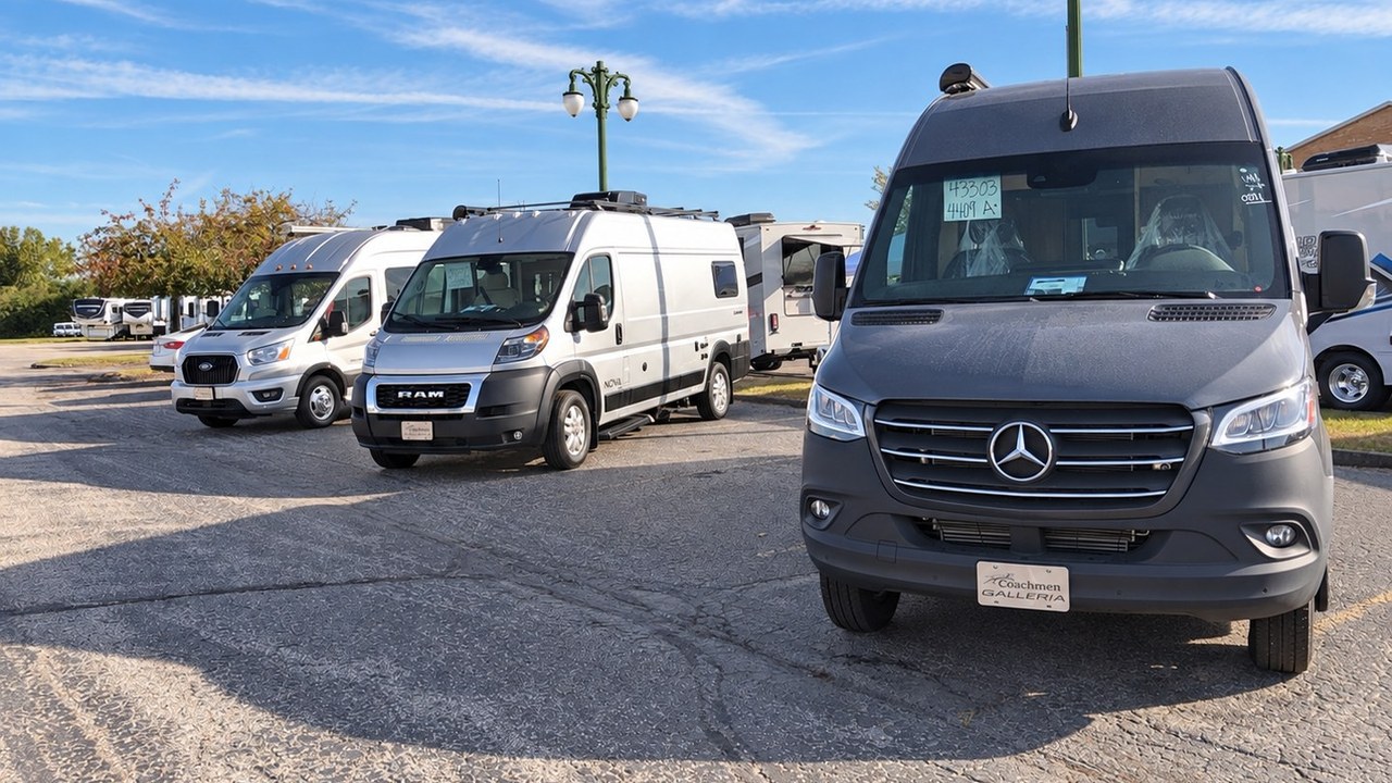Ford Transit, Ram ProMaster and Mercedes-Benz Sprinter camper vans parked side by side on a dealer lot
