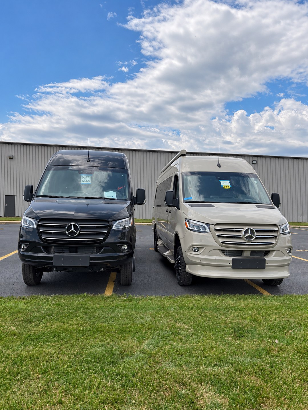 Two Mercedes-Benz Sprinter camper vans parked side by side