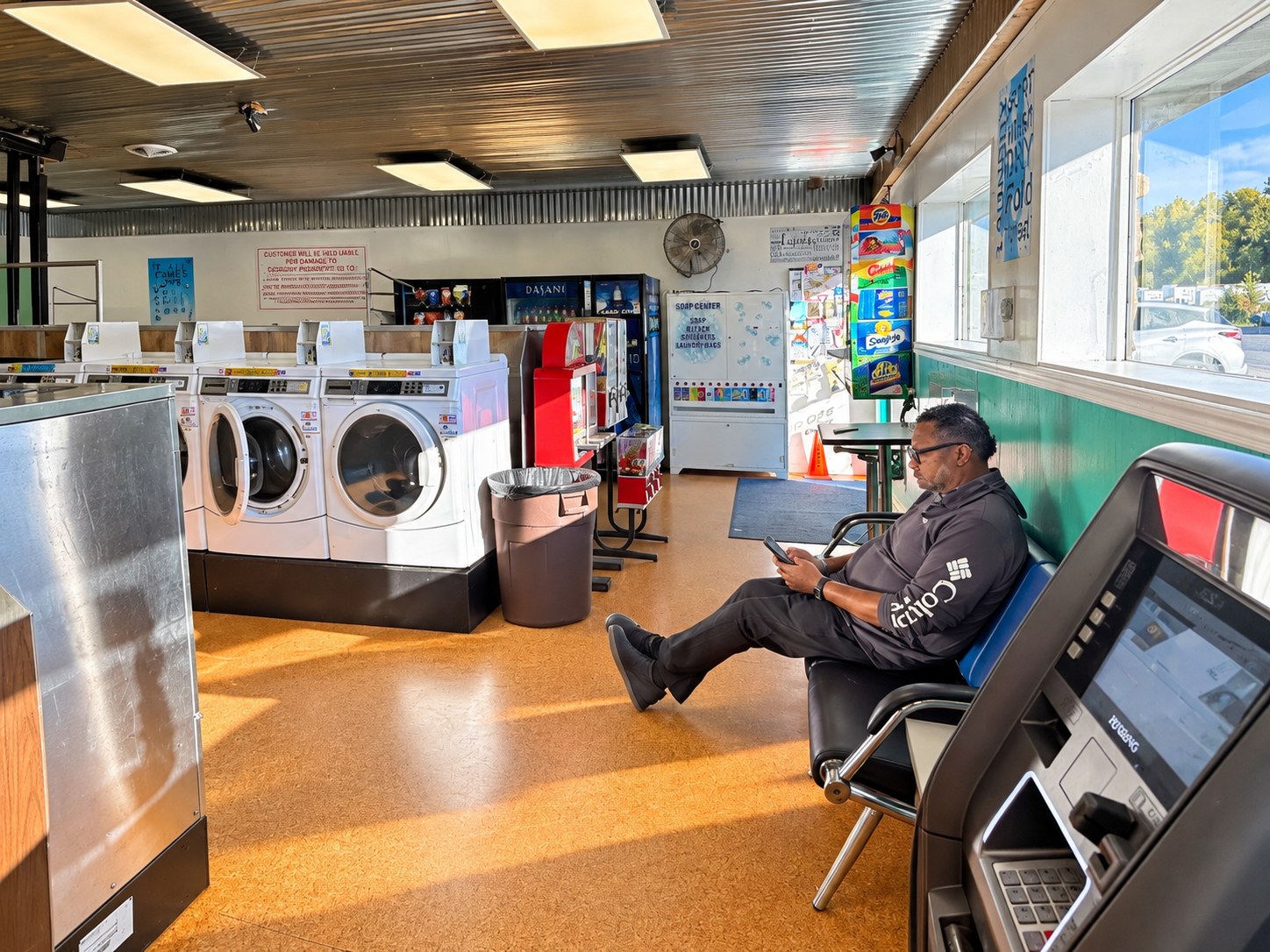 Hank Strange seated in the laundromat while waiting for laundry during camper van travels